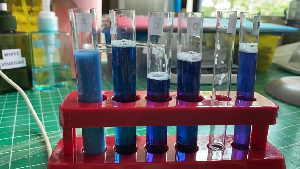 Test tubes of blue liquid on a studio bench